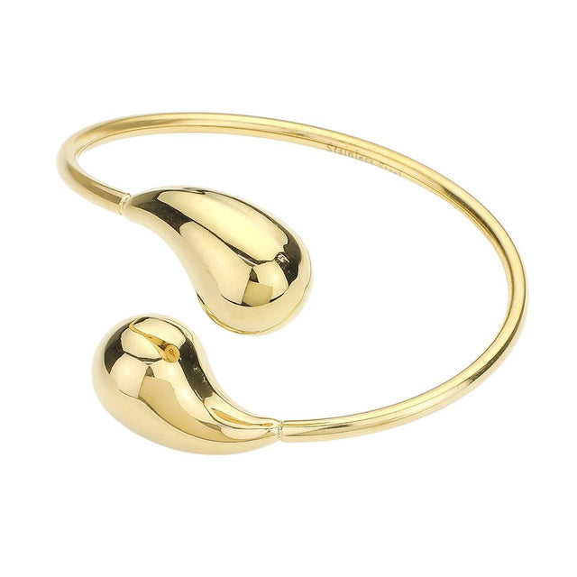 Gold Stainless steel teardrop tip wire bangle bracelet offers a sleek and modern design, perfect for any outfit. Made with durable materials, it is both stylish and long-lasting. Add a touch of elegance to your wardrobe with this stunning bracelet.