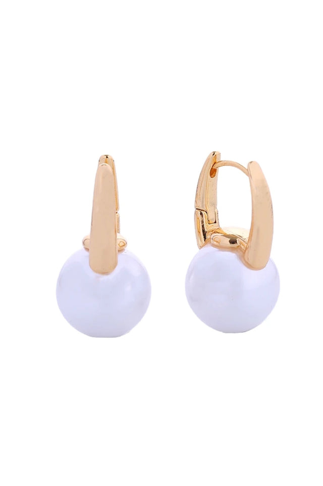 Gold Elegant pearl drop huggie earrings crafted in 14K gold or white gold-dipped brass. These hypoallergenic earrings feature lustrous pearls suspended from a secure huggie design, perfect for everyday wear or special occasions. Diameter: 1.7cm Lead and nickel compliant for sensitive skin Handcrafted in Korea 