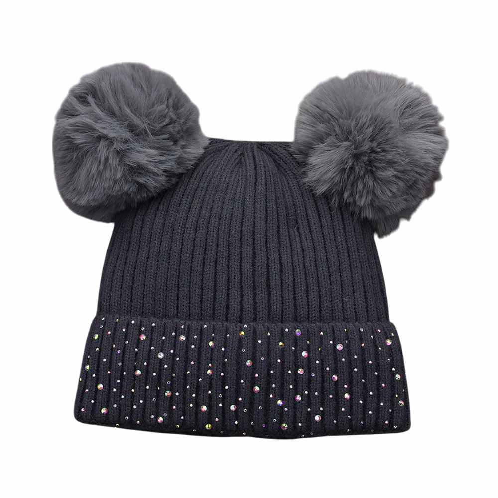 Gray Double Pom Pom Bling Studded Cuff Beanie Hat, stay warm and stylish with our beanie hat. This hat features two pom poms, studded accents, and a cozy cuff.