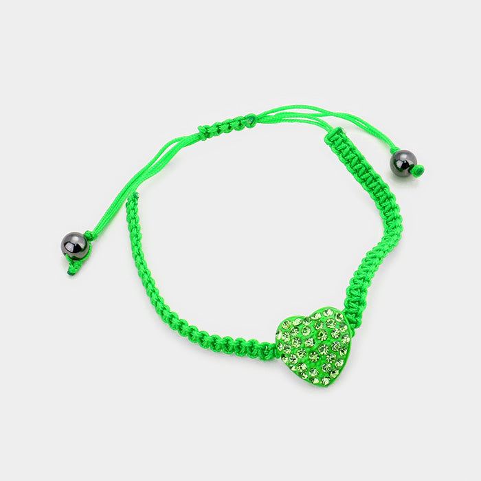 Green Crystal Pave Heart Cinch Bracelet is beautifully crafted with sparkling crystals in a stunning pave design. This elegant and versatile piece enhances any outfit with its sophisticated charm. Elevate your style effortlessly with this timeless accessory.