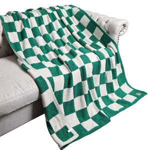 Green Reversible Checkerboard Patterned Throw Blanket, is perfect for adding a touch of style to any home. The reversible checkerboard pattern is eye-catching and timeless, making any living space look more inviting. Comfort and style in one cozy blanket! An ideal winter gift choice.