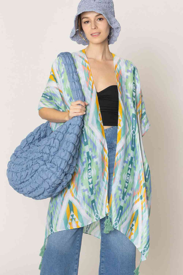 Green Embrace bohemian style with this striking Aztec Pattern Print Tassel Kimono. Crafted from lightweight 100% polyester, this versatile piece features bold geometric patterns inspired by traditional Aztec designs, complete with decorative tassels for added flair. Perfect for layering over dresses, swimwear, or casual outfits, it offers effortless coverage and movement. With generous dimensions of 35.4" x 35.4", it drapes beautifully on most body types. Ideal for beach days, festivals, or relaxed everyday