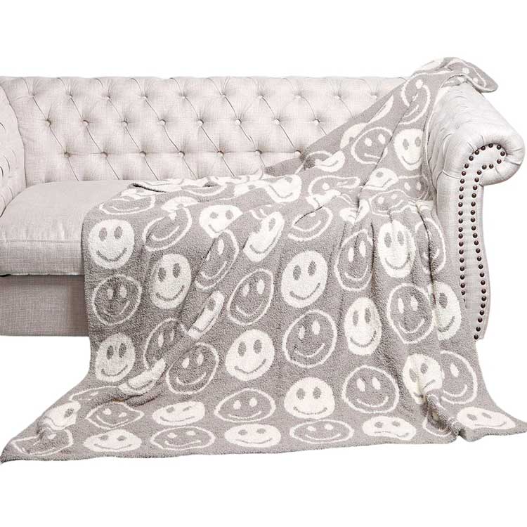 Grey Smile Patterned Reversible Throw Blanket, this ultra-soft throw provides warmth and comfort to any living space. It's made from high-quality materials and features a reversible design featuring a fun, cheerful smile pattern that adds a touch of personality to your home. Perfect winter gift for family and friends.