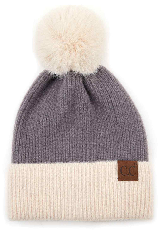 Grey The C.C Solid Color Pom Beanie with Beige Cuff features a classic solid knit design accented by a contrasting beige cuff for a stylish, modern touch. Topped with a fluffy pom and crafted from soft, stretchy fabric, it delivers cozy warmth and a comfortable fit for chilly days.