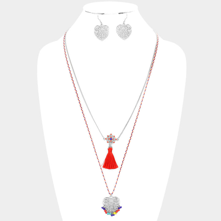 Heart Pendant Necklace with Tassel features a beautiful tassel design, making it a unique and stylish addition to any outfit. Crafted with expert precision, this necklace is sure to make a statement. Handmade with care, it symbolizes love and will be cherished for years to come. 