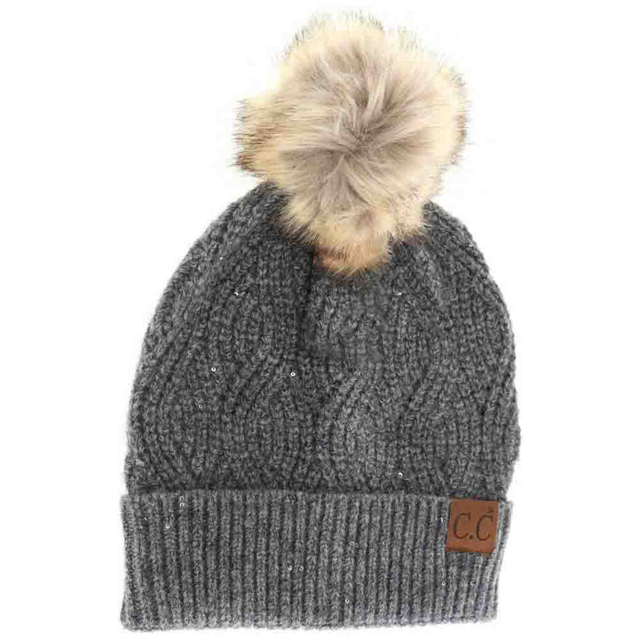 HeatherGrey Sequin Brioche Cable Knit Fur Pom C.C Beanie combines classic craftsmanship with a modern touch. Featuring a soft brioche cable knit pattern enhanced by subtle sequins, this beanie adds understated sparkle to cold-weather style. The plush fur pom enhances warmth and a refined aesthetic, making it an ideal accessory for both functionality and fashion during chilly days. Durable and comfortable, it delivers expert-level design that complements any winter wardrobe. 