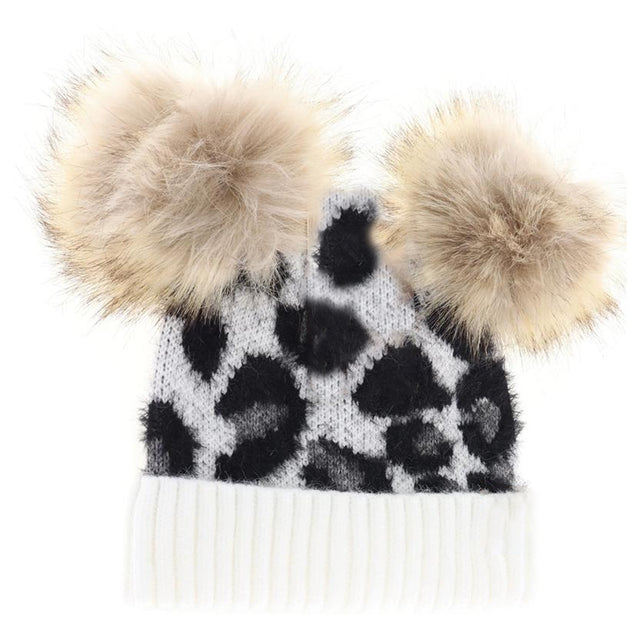 Ivory BABY Leopard Double Pom C.C Beanie combines playful style with cozy warmth, featuring a soft knit design adorned with cute leopard print and two fluffy pom-poms. Crafted for comfort and durability, it provides gentle insulation for delicate heads while adding an adorable touch to any baby’s outfit. Ideal for chilly days, this beanie keeps your little one snug and stylish with expert-crafted quality. 