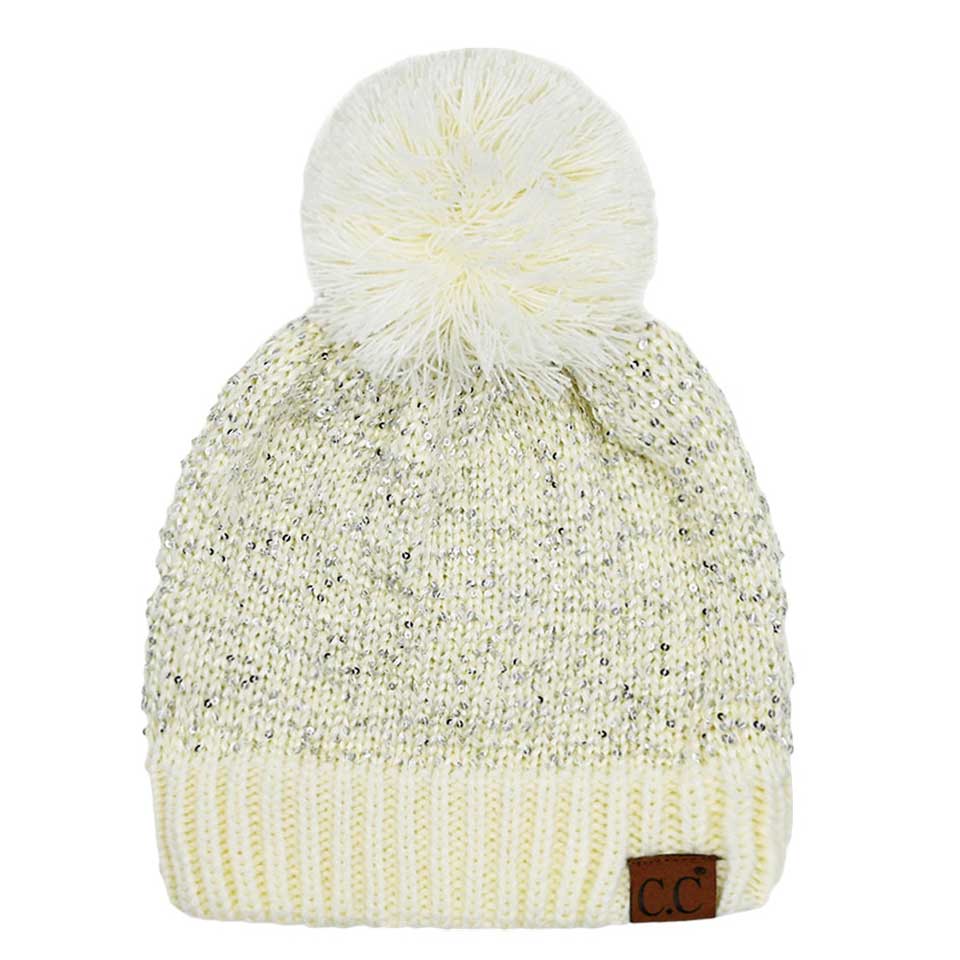 Ivory C.C Sequin Cuff Pom Pom Beanie Hat, Stay warm and stylish even during the coldest days with this. This hat is made with durable materials for long-lasting comfort and features a cozy and fashionable pom pom on the top. The added sequin cuff adds a glamorous touch to the classic beanie style. Perfect winter gift idea.