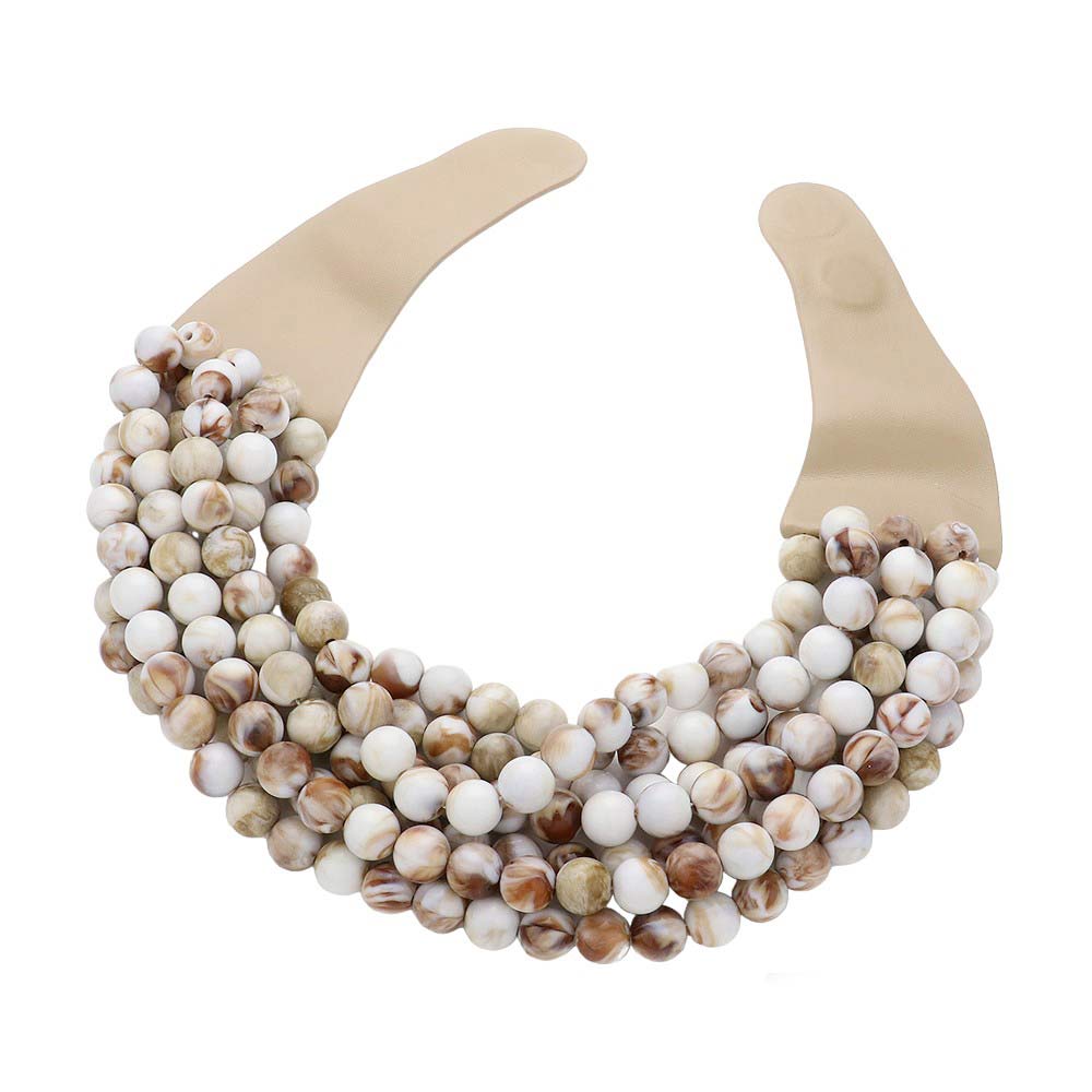 Ivory Chunky Metal Ball Beaded Multi Layered Faux Leather Magnetic Necklace, Add a bold touch to your wardrobe with this necklace. Featuring multiple strands of soft faux leather adorned with chunky metal ball beads, this statement necklace effortlessly elevates any outfit. The magnetic clasp ensures easy wear.