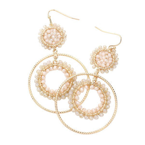 Ivory Faceted Beaded Metallic Tiered Circle Dangle Earrings, will add a touch of subtle sparkle to your outfit. Crafted with a modern and eye-catching design, these earrings feature a faceted bead, a tiered circle, and a dangle pattern for a unique and stylish look. Perfect for either a special occasion or everyday wear.