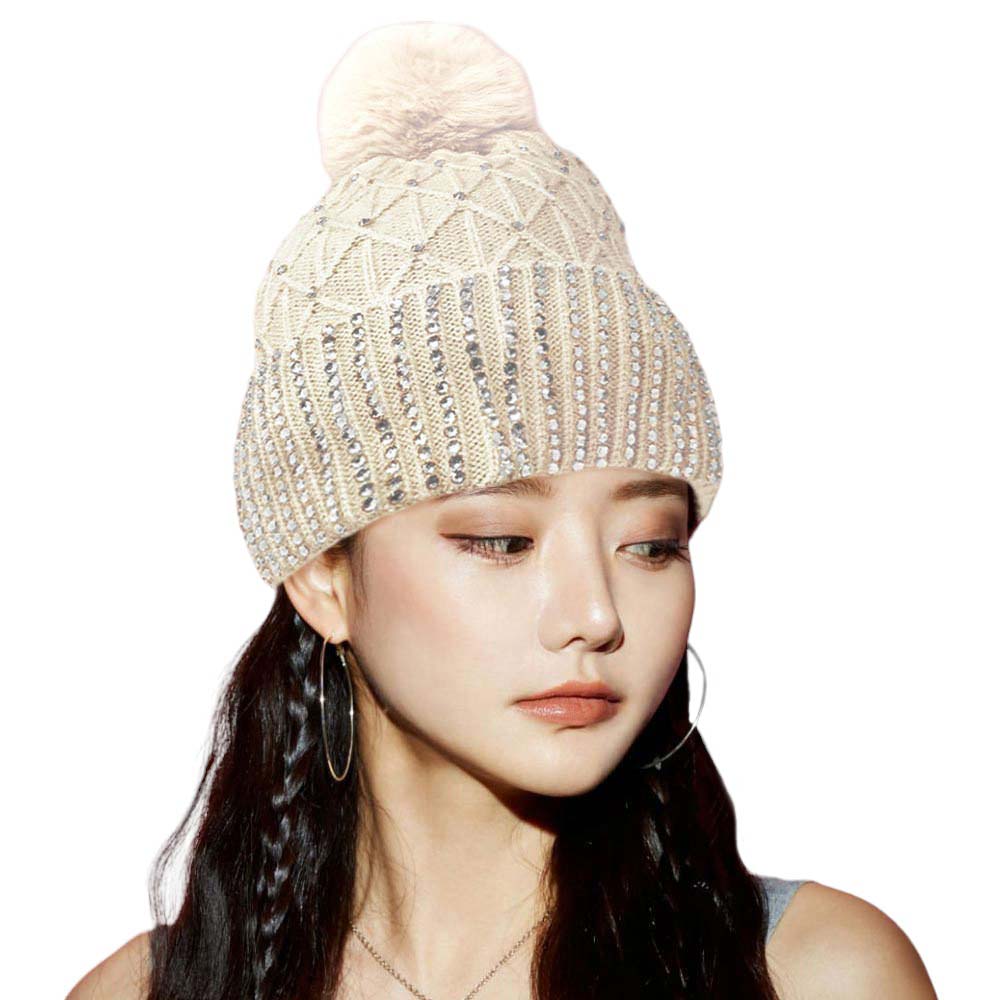Ivory Fleece Lining Rhinestone Embellished Pom Pom Beanie Hat. Stay warm and stylish with this. Made of a cozy knit blend and featuring a luxurious rhinestone embellishment, this hat provides a fashion-forward look while keeping you warm and comfortable. Perfect seasonal gift idea for fashion-loving close people!