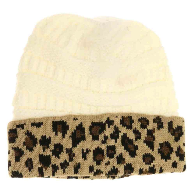 Ivory Leopard Print CC Beanie Tail combines stylish leopard patterning with practical design, featuring a convenient tail opening perfect for ponytails or buns. Crafted from soft, breathable fabric, this beanie ensures comfortable wear during colder days while keeping your hair effortlessly in place. Ideal for outdoor activities or casual outings, it offers a blend of fashion and function that enhances your winter wardrobe. 