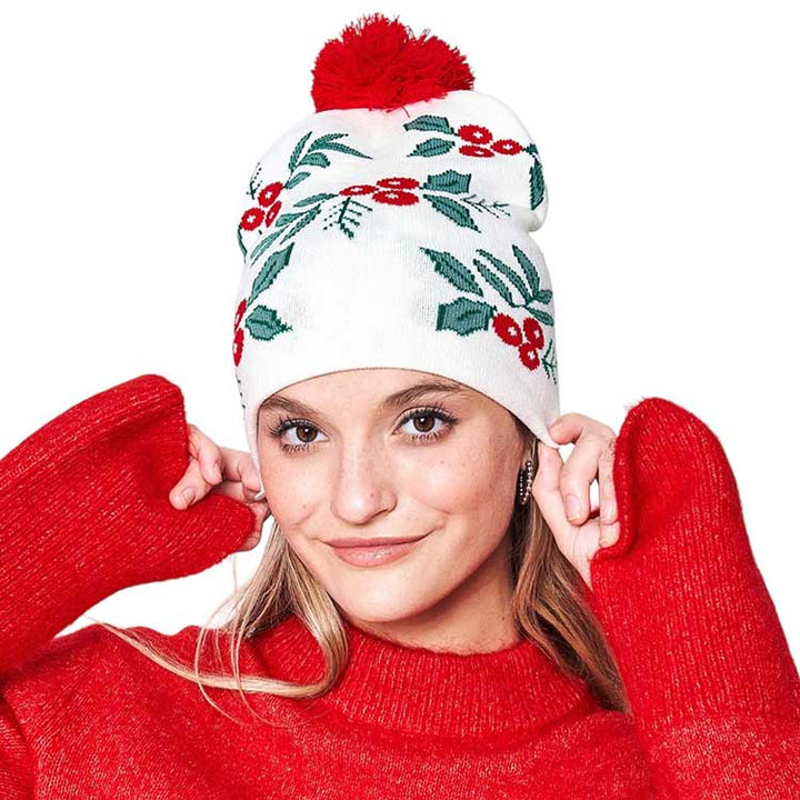 Ivory Mistletoe Pom Pom Beanie Hat. You'll love the classic look of the hat. Its cozy design combines style and comfort for a winter-ready look. Made with high-quality materials, this beanie is soft. Enjoy the festive look of the mistletoe pom pom, perfect for the winter season. Ideal gift item for any winter occasion.