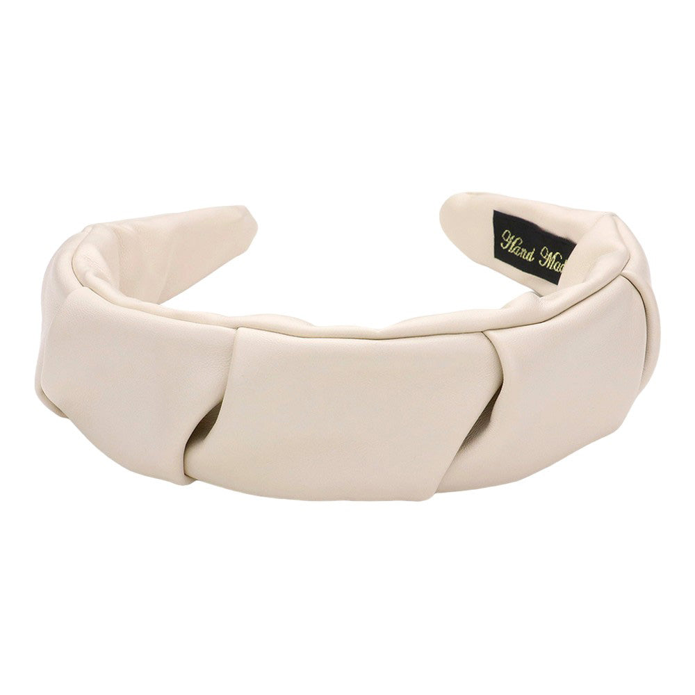 Ivory Pleated Solid Faux Leather Headband, This stylish accessory adds an elegant touch to any outfit. Made with high-quality materials, it is both comfortable and durable. The pleated design offers a unique, sophisticated look, while the faux leather adds a touch of luxury. Perfect for any formal or casual occasion wear.