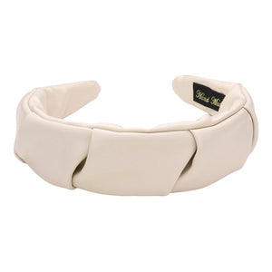 Ivory Pleated Solid Faux Leather Headband, This stylish accessory adds an elegant touch to any outfit. Made with high-quality materials, it is both comfortable and durable. The pleated design offers a unique, sophisticated look, while the faux leather adds a touch of luxury. Perfect for any formal or casual occasion wear.
