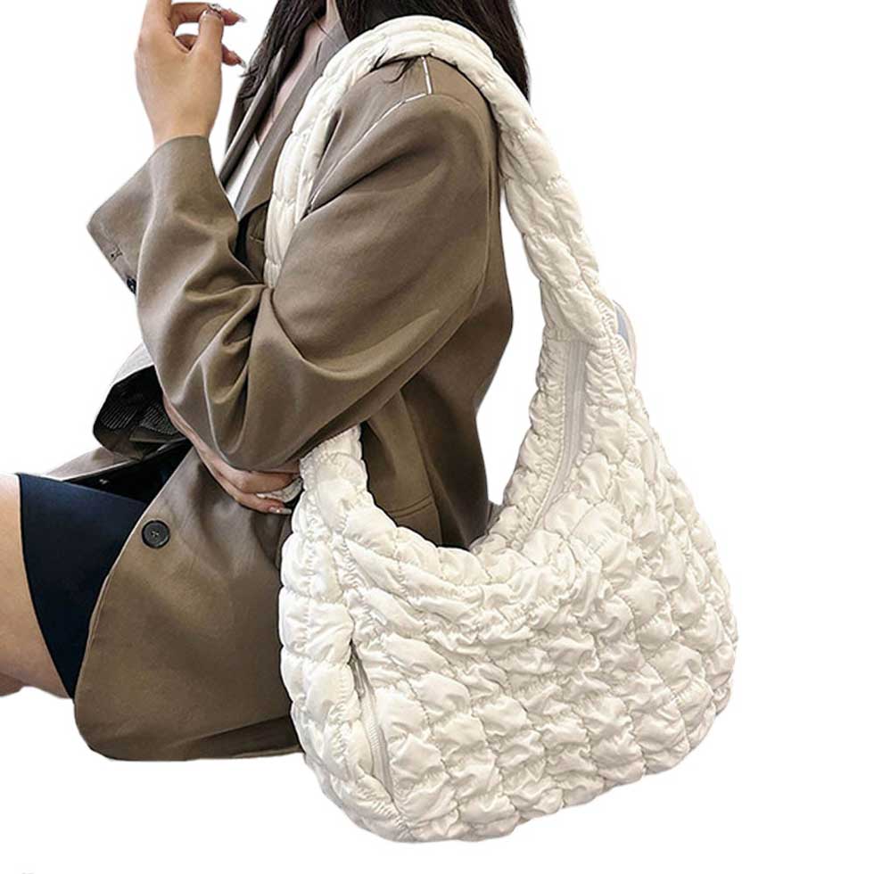 Ivory Quilted Puffer Shoulder Crossbody Bag Cloud Bag, offers a sleek and stylish way to carry your essentials. Made with a unique quilted puffer design, this bag provides both durability and lightweight comfort. The perfect accessory for any occasion, it offers the perfect blend of fashion and function.