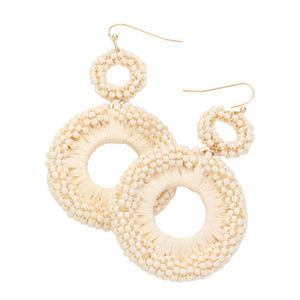 Ivory Seed Beaded Raffia Wrapped Open O Link Dangle Earrings, Discover the perfect blend of style and sustainability with these. Crafted with natural raffia and intricately beaded, these earrings add a touch of bohemian chic to any outfit. Plus, with an open O link design, they're lightweight and comfortable to wear all day.