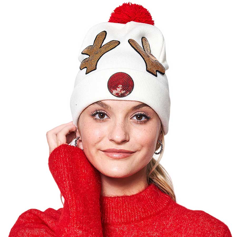 Ivory Sequin Embellished Rudolph Pom Pom Beanie Hat is the perfect addition to any winter wardrobe. Crafted from soft fabric and featuring a Rudolph design with sequin detailing, this hat provides warmth, comfort, and style. Gift it to anyone in your life for a functional and fashionable accessory.
