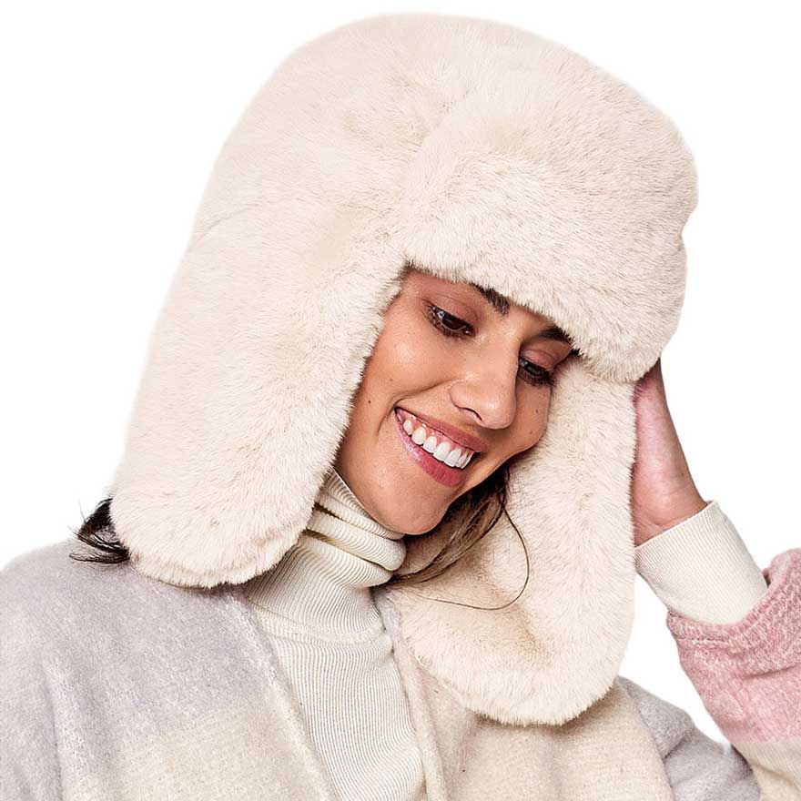 Ivory Solid Faux Fur Trapper Hat, is perfect for winter outdoor adventures. Crafted from soft faux fur, the hat will comfortably protect your head from the cold while looking stylish. With its windproof design, this hat is a must-have for winter weather. Ideal gift for your friends and family members on colder days.