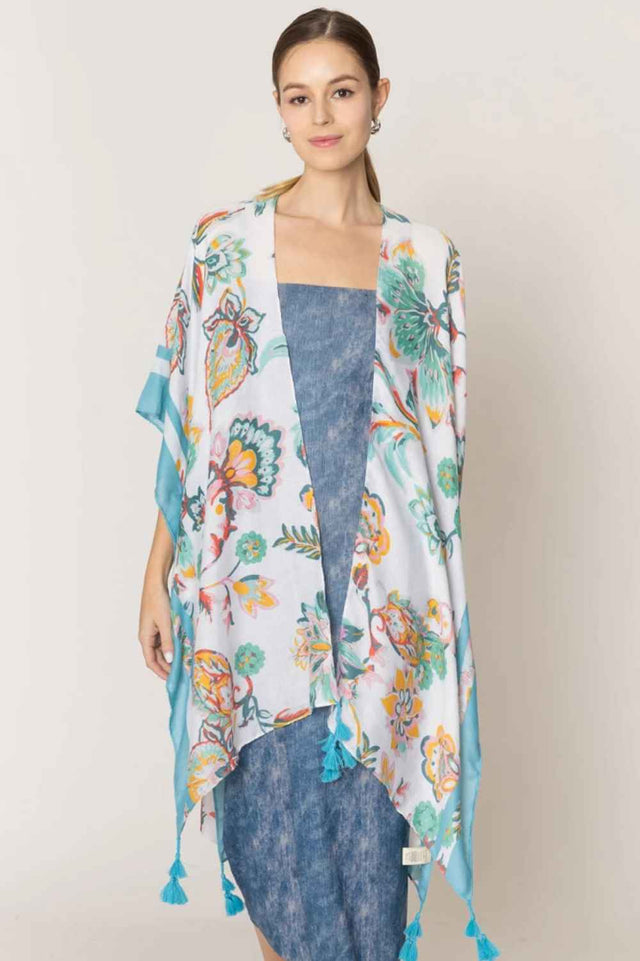 Ivory Effortless elegance meets bohemian charm with this stunning floral print kimono. Crafted from lightweight 100% polyester, this versatile piece features a beautiful floral design accented with delicate stripe detailing along the edges and playful tassels for added movement and flair. Perfect for layering over dresses, swimwear, or casual outfits, this kimono drapes beautifully and transitions seamlessly from beach days to evening gatherings.