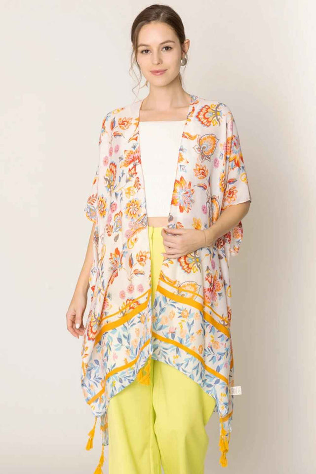 Ivory Embrace effortless elegance with this stunning Floral Print Tassel Kimono. Crafted from lightweight 100% polyester, this versatile piece features a beautiful floral design and charming tassel details that add movement and dimension. With generous dimensions of 35.4" x 35.4", it drapes beautifully over any outfit, perfect for layering during warmer months or as a beach cover-up.