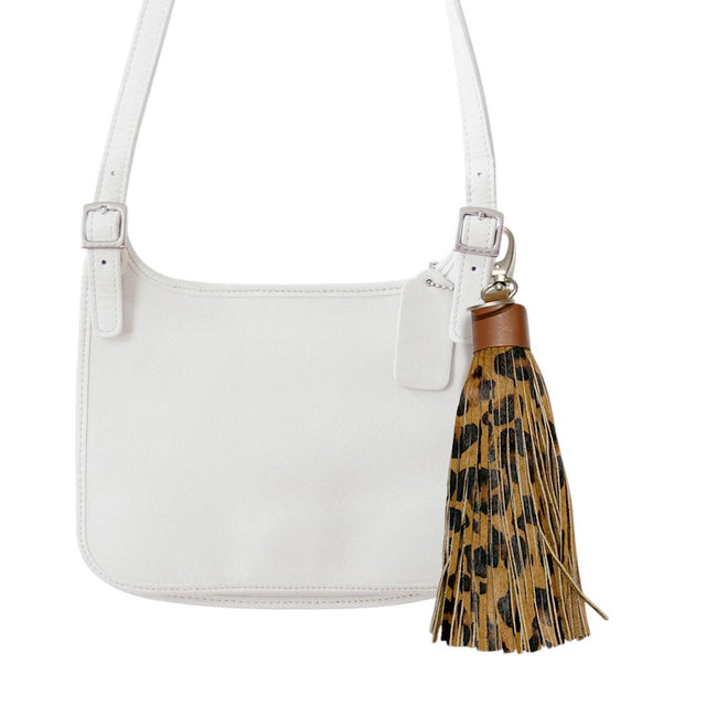 Leopard Leopard Patterned Genuine Leather Tassel Bag Charm adds a stylish touch to any bag with its trendy leopard pattern. Made from high-quality leather, it's a durable and chic accessory that enhances the look of your bag. Elevate your style with this must-have bag charm. 