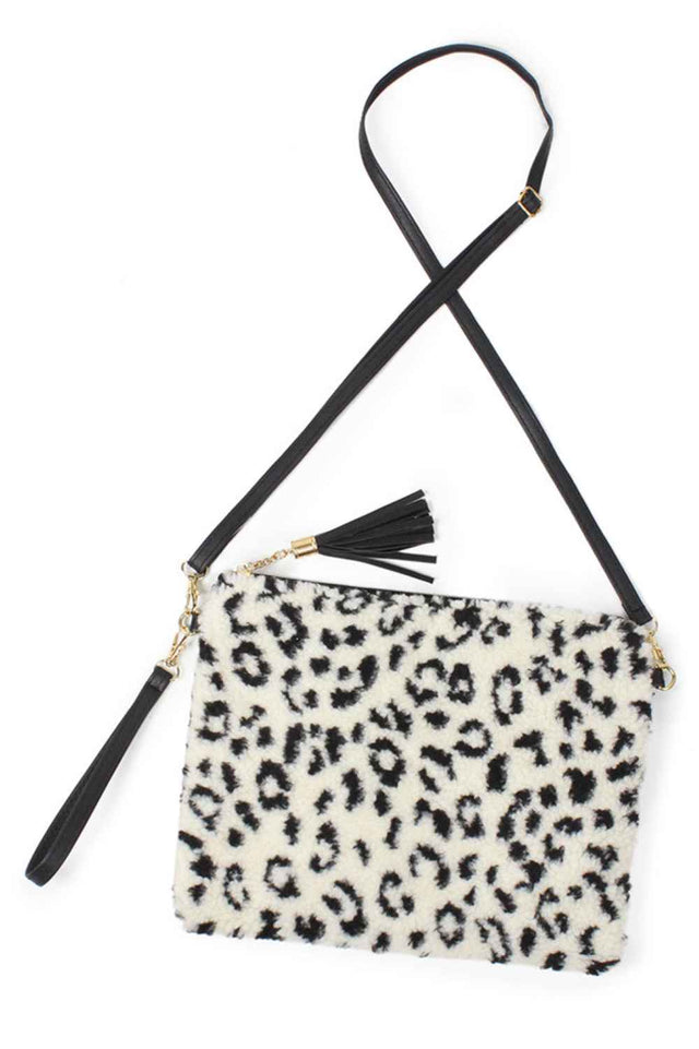 Leopard Elevate your everyday style with this striking Leopard Fur Crossbody Clutch Bag. Crafted from soft 100% polyester, it features a bold leopard print that adds instant edge to any outfit. The compact 11" x 8.5" size is perfect for carrying essentials while keeping your hands free. Designed with a crossbody strap for comfortable, hands-free wear, this versatile clutch transitions seamlessly from day to night. 
