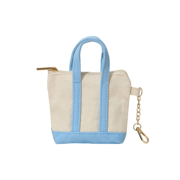 Light Blue Mini Canvas Pouch Bag doubles as a chic bag charm, combining style with practicality. Crafted from durable canvas, it offers a compact space perfect for carrying essentials like keys, cards, or small cosmetics. Its lightweight design attaches easily to your handbag, adding a trendy accent while keeping your valuables within reach. Ideal for those who value convenience and a polished look in everyday accessories.