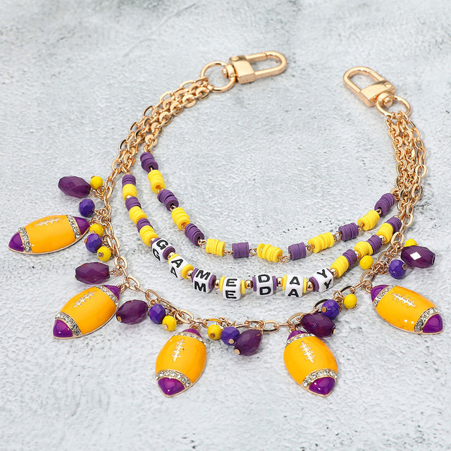 Madeline Love Gold, Purple , Yellow Football Charm Embellished GAME DAY Heishi Beaded Layered Bag Charm - Bags & Wallets