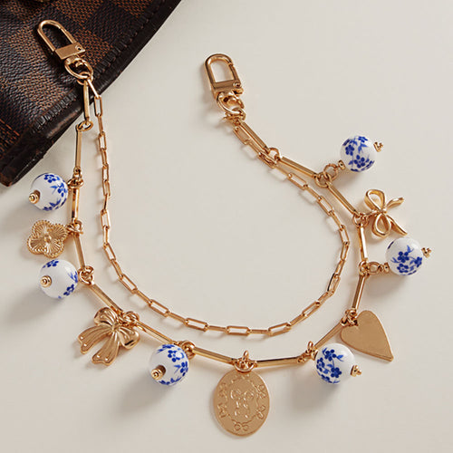 Floral Ceramic Ball Metal Bow Heart Quatrefoil Charm Station Layered Chain Bag Charm - Gold