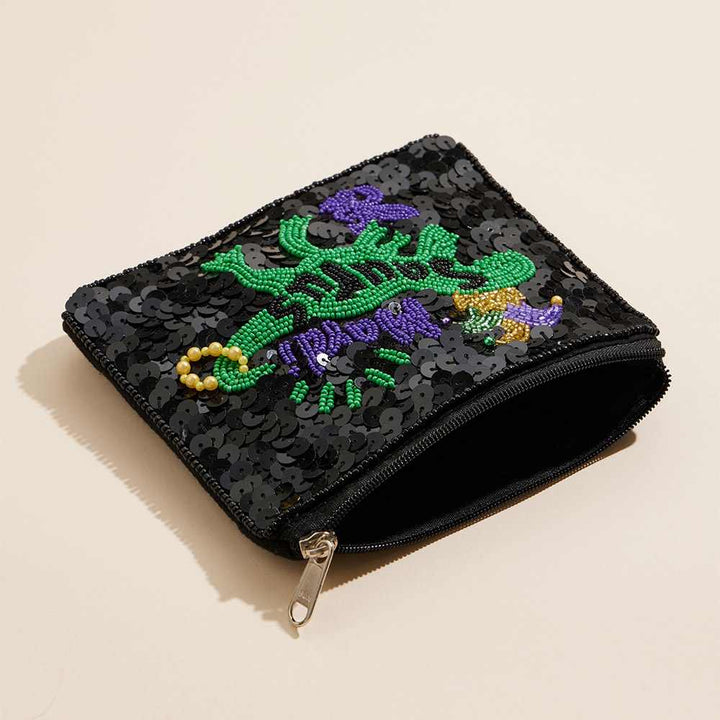 Mardi Gras Saurus Sequin Seed Beaded Mini Pouch Bag adds a touch of sparkle to your outfit. Intricate beadwork and playful sequins create a festive and eye-catching design. This compact pouch is perfect for keeping essentials close, making it ideal for special occasions and events.