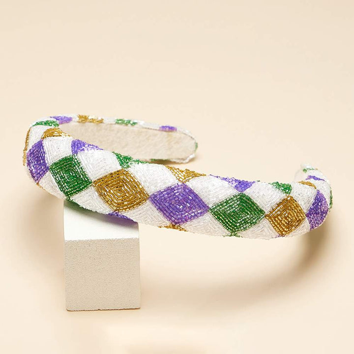 Mardi Gras Seed Beaded Headband is a must-have accessory for festive celebrations. Crafted with vibrant, colorful beads in traditional Mardi Gras hues, it adds a touch of fun and flair to any outfit. Ideal for parades, parties, and other special occasions, it’s perfect for elevating your festive style. 