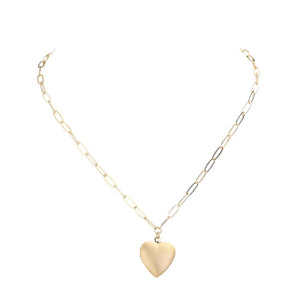 This fashionable necklace features a matte metal heart locket pendant and a paperclip chain. The heart locket allows you to store a sentimental photo or small keepsake. The on-trend paperclip chain adds a unique touch to any outfit. Matte Finish Pendant Necklace. Heart Locket Paperclip Link. Matte Metal Heart Locket.