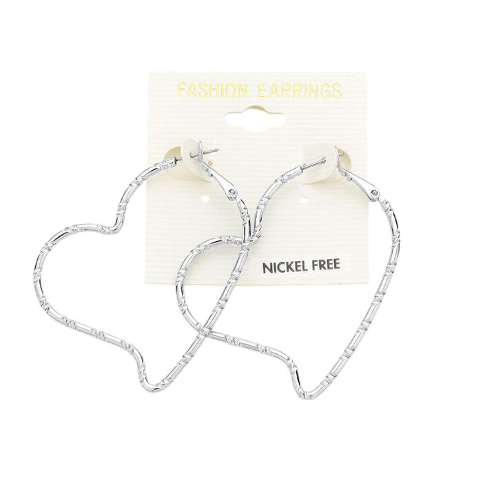 Metal Heart Hoop Earrings are a trendy and elegant addition to any jewelry collection. Made from high-quality metal, these earrings feature delicate heart-shaped hoops that add a touch of romance to any outfit. Perfect for any occasion, these earrings are a must-have for any fashion-forward individual. 