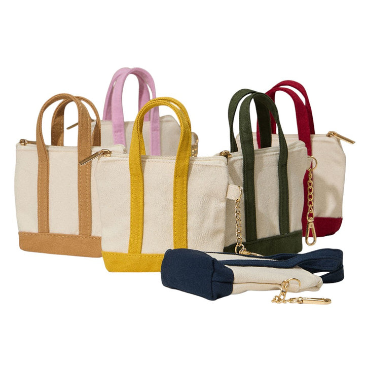 Mini Canvas Pouch Bag doubles as a chic bag charm, combining style with practicality. Crafted from durable canvas, it offers a compact space perfect for carrying essentials like keys, cards, or small cosmetics. Its lightweight design attaches easily to your handbag, adding a trendy accent while keeping your valuables within reach. Ideal for those who value convenience and a polished look in everyday accessories.