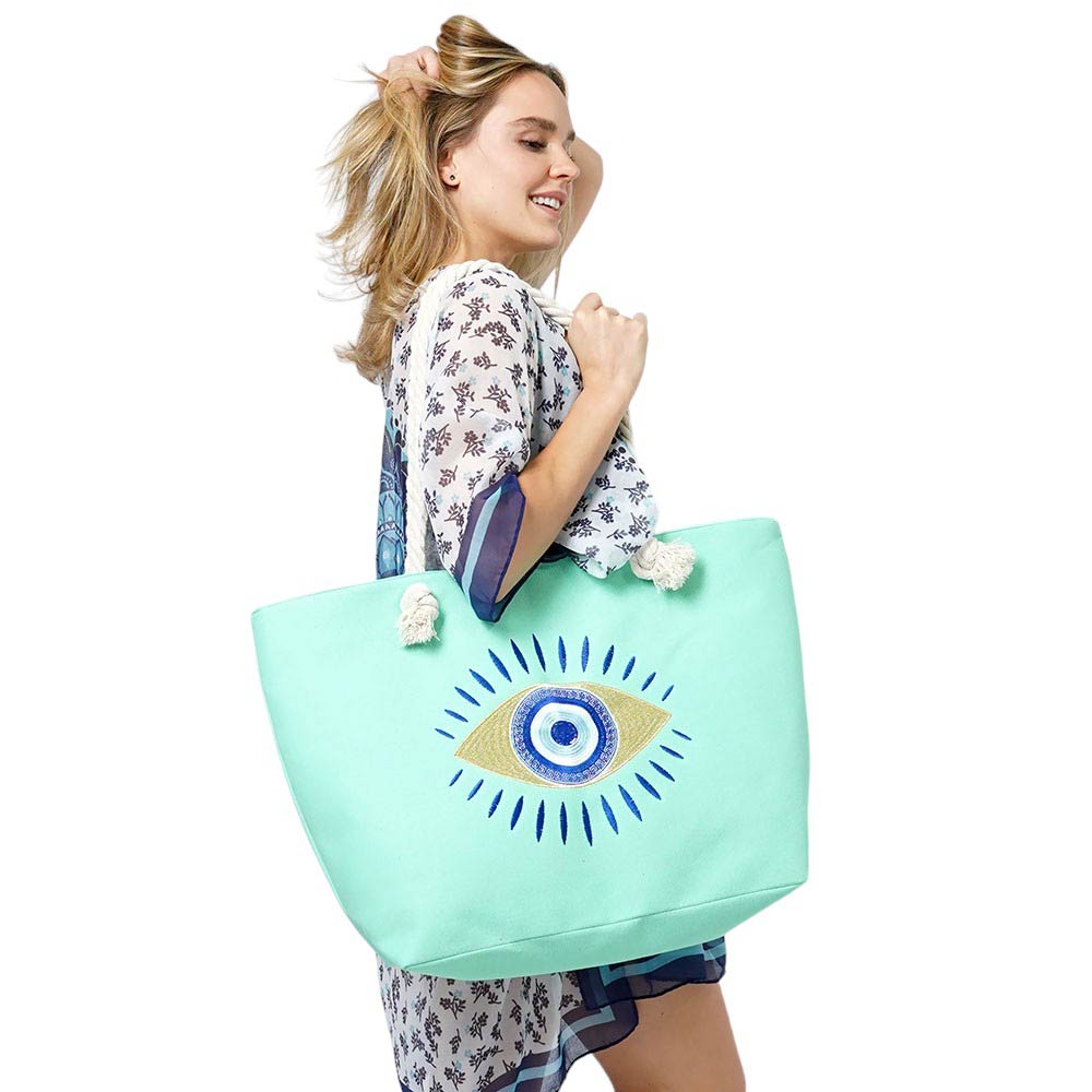 Ivory Evil Eye Beach Bag Tote Bag combines fashion and protection, making it the ultimate beach essential. With its vibrant design and sturdy construction, it's perfect for carrying all your beach essentials while warding off any negative energy. Stay stylish and protected with this must-have tote bag.
