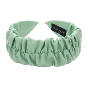 Mint Pleated Solid Faux Leather Headband, This stylish accessory adds an elegant touch to any outfit. Made with high-quality materials, it is both comfortable and durable. The pleated design offers a unique, sophisticated look, while the faux leather adds a touch of luxury. Perfect for any formal or casual occasion wear.