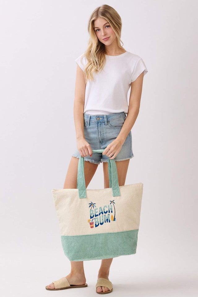 Mint Carry your beach essentials in style with this fun BEACH BUM terry tote bag. Featuring a playful letter design with palm tree and drink print, it's the perfect companion for days by the water. Made from a durable polyester and polyamide blend, this spacious 22" x 16" x 6" bag keeps everything organized with a secure zipper closure and convenient inner pocket. Whether you're heading to the shore or the pool, this tote combines practicality with vacation vibes.