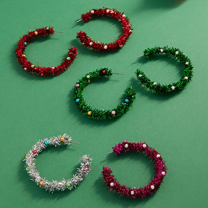 Celebrate the season with these festive tinsel hoop earrings, decorated with miniature ornament accents for a cheerful holiday touch. Lightweight and eye-catching, they’re perfect for adding playful flair to party outfits, winter gatherings, or seasonal celebrations.