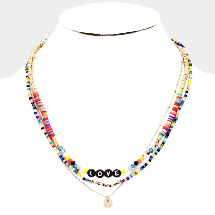 Multi-Color Bead Statement Love Layered Necklace is the perfect accessory to add a touch of fun and color to any outfit. The layered design adds depth and dimension, while the eclectic mix of beads creates a unique, eye-catching look. Elevate your style with this love-inspired necklace.