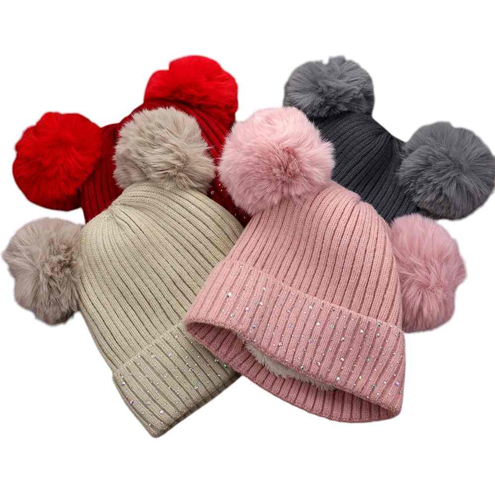 Multi Double Pom Pom Bling Studded Cuff Beanie Hat, stay warm and stylish with our beanie hat. This hat features two pom poms, studded accents, and a cozy cuff.