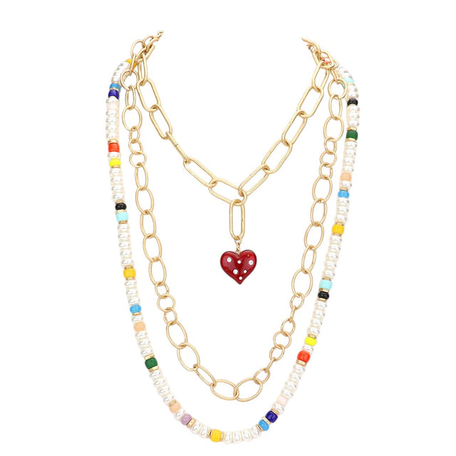 Multi Heart Pendant Accented Pearl Resin Beaded Triple Layered Necklace adds a touch of elegance and sophistication to any outfit. The heart pendant adds a sentimental touch, while the layered design creates a bold and eye-catching look. Made with high-quality materials, this necklace is both beautiful and durable.