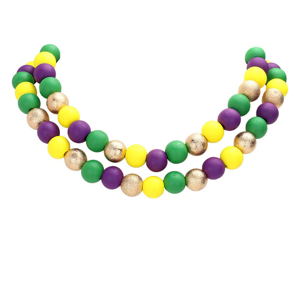 Multi Mardi Gras Brass Metal Wood Ball Double Layered Necklace, Crafted with premium brass metal, it features a double-layered design for enhanced style and texture. The natural wood ball finish offers an eye-catching contrast and a bold look. Up your style game with this timeless and stylish piece.