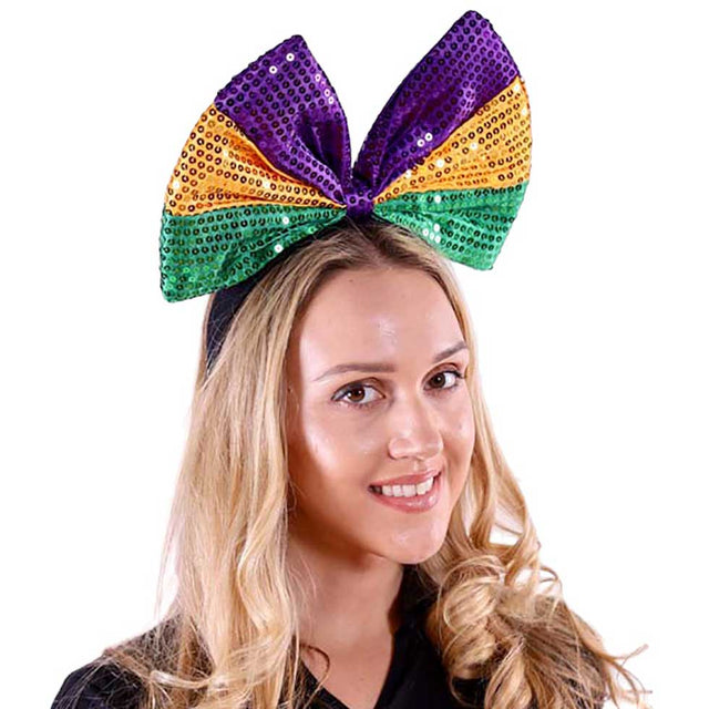 Multi Mardi Gras Sequin Ribbon Headband, is crafted from durable fabric and features metallic sequins for a bold, eye-catching look. Perfect for adding a touch of glitz to your outfit, this stylish accessory is sure to turn heads this Mardi Gras season. Ideal festive gift accessory idea.