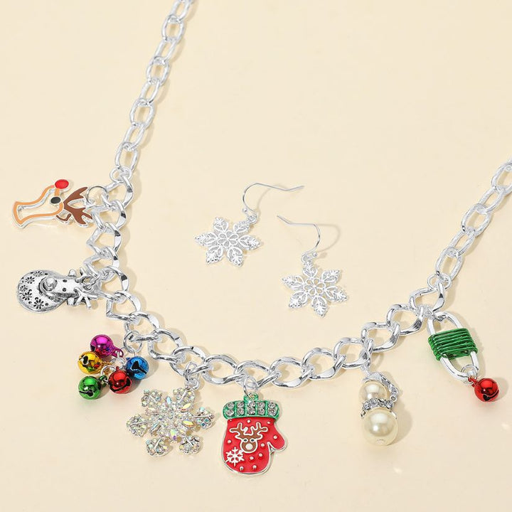 Holiday necklace featuring festive charms like mittens, bells, snowflakes, and reindeer. Comes with matching snowflake earrings. A cheerful accessory for seasonal events or gifting.