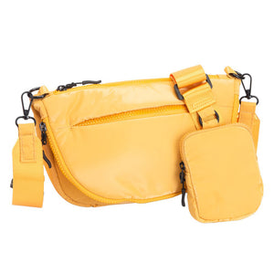 Mustard Glossy Puffer Half Moon Crossbody Bag, the lightweight, stylish design features a durable water-resistant nylon that is perfect for outdoor activities. The adjustable shoulder strap makes it easy to sling across your body for hands-free convenience. Carry your essentials in style and comfort with this fashionable bag.