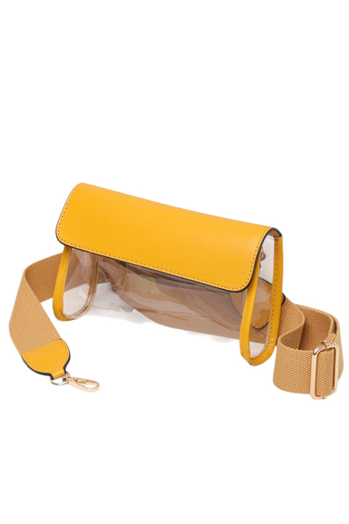 Solid Trim Clear Stadium Crossbody Bag combines transparency with reinforced solid trim for enhanced durability and style. Designed to meet stadium security requirements, it offers easy visibility of contents while maintaining a sleek, structured look. Its crossbody design ensures comfortable, hands-free wear, making it a practical choice for events where convenience and compliance are essential.