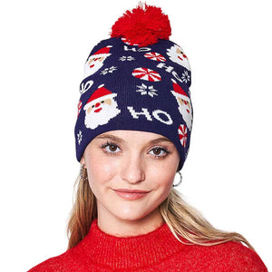 Navy HoHoHo Message Santa Claus Candy Cane Pom Pom Beanie Hat. It's perfect for gifting to your loved ones on Christmas, or to treat yourself. Featuring an iconic message from Santa Claus himself, HoHoHo, this hat is perfect for spreading the cheer! It is an ideal winter accessory.
