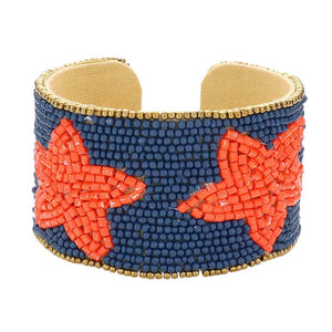 Navy Orange This Game Day Beaded Star Accented Cuff Bracelet adds a stylish touch to any ensemble. The beaded star accents on the cuff give it a unique, eye-catching design, perfect for game day or any day. Wear it to show your support for your favorite team - you're sure to stand out from the crowd. 