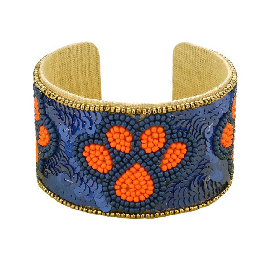 Red White This stylish Game Day Sequin Seed Beaded Paw Accented Cuff Bracelet is the perfect way to show your team spirit. Crafted with sparkling sequins and beads, this bracelet features an eye-catching paw accent, perfect for any sports fan. Show your true allegiance on game day with this fashionable and unique accessory.
